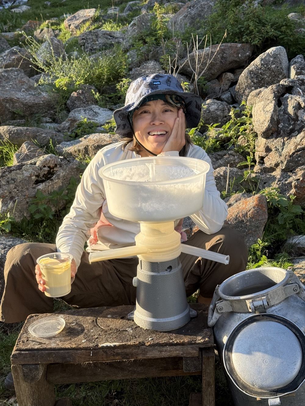 A guest making fresh cream with a hand separator in the mountains