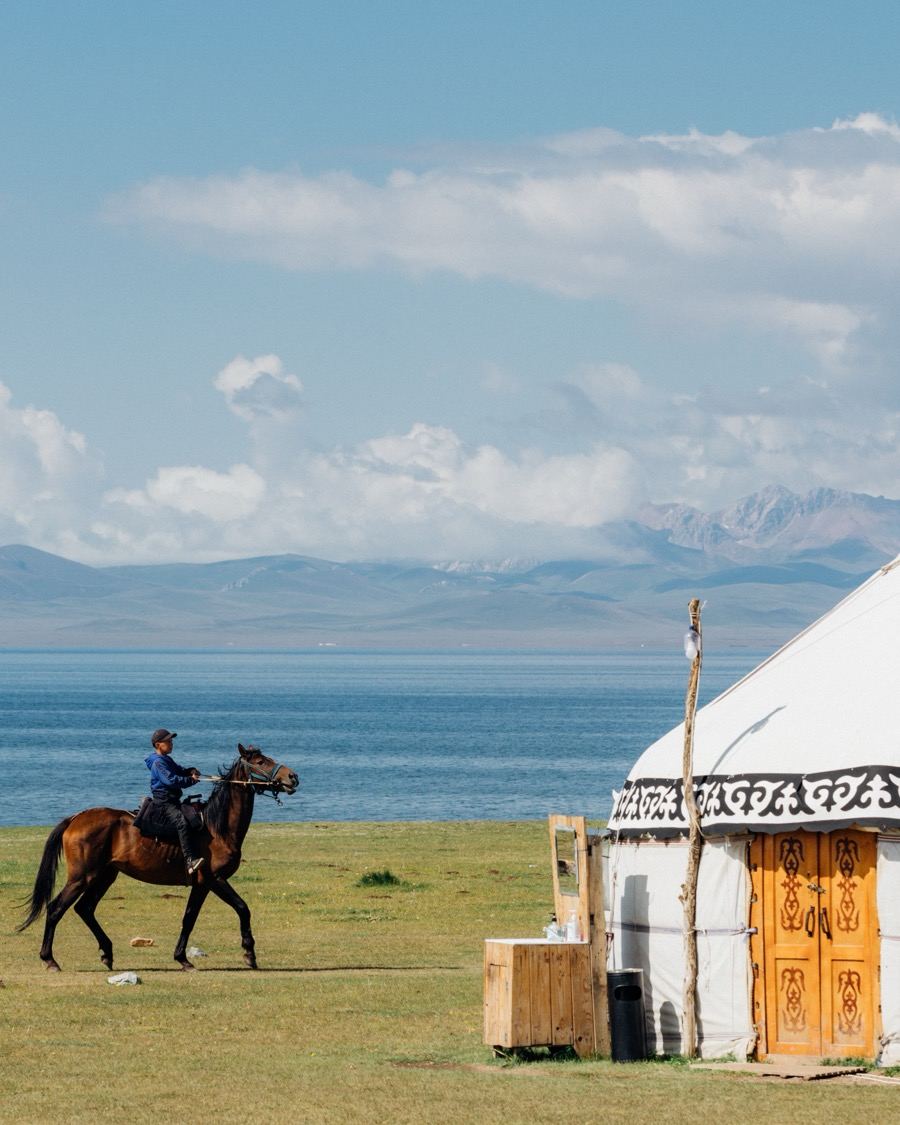A young rider passing a yurt by Song-Kul Lake