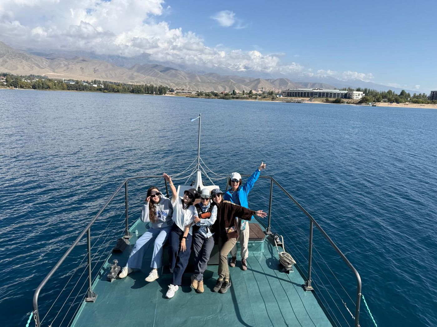 Guests at the bow of a boat on Issyk-Kul