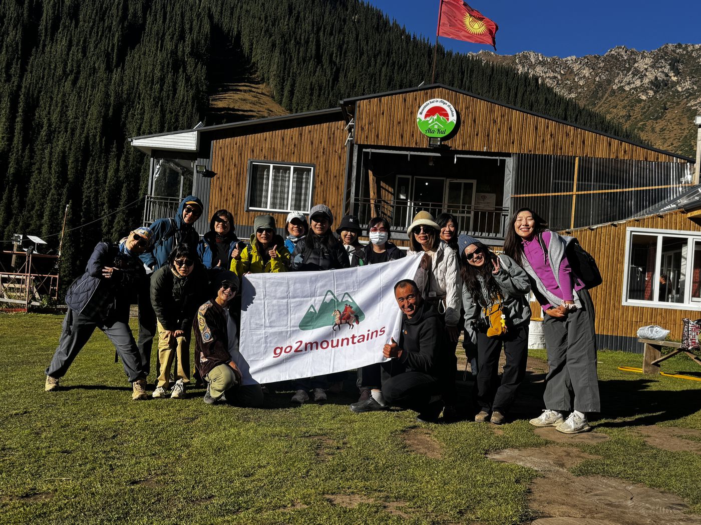 Our group with the go2mountains banner at a mountain lodge
