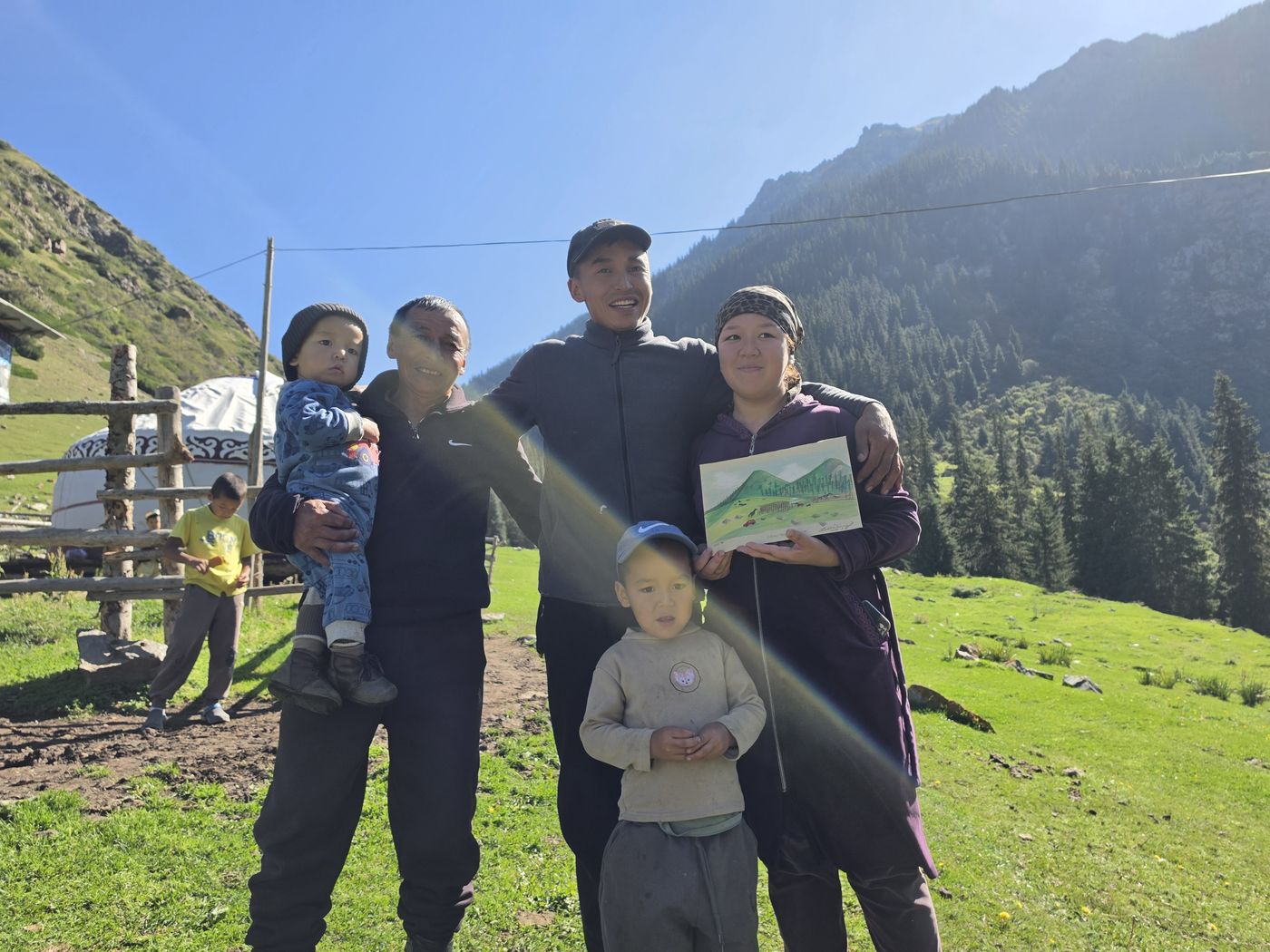 Guests with a nomad family by their yurt