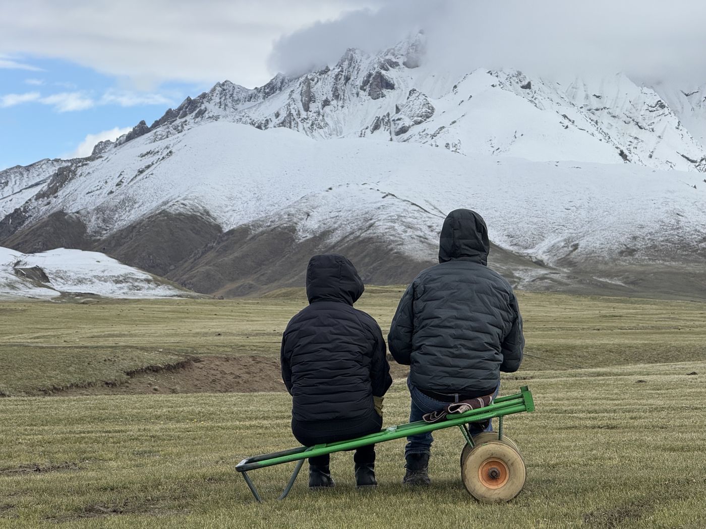 Two guests looking at a snowy peak