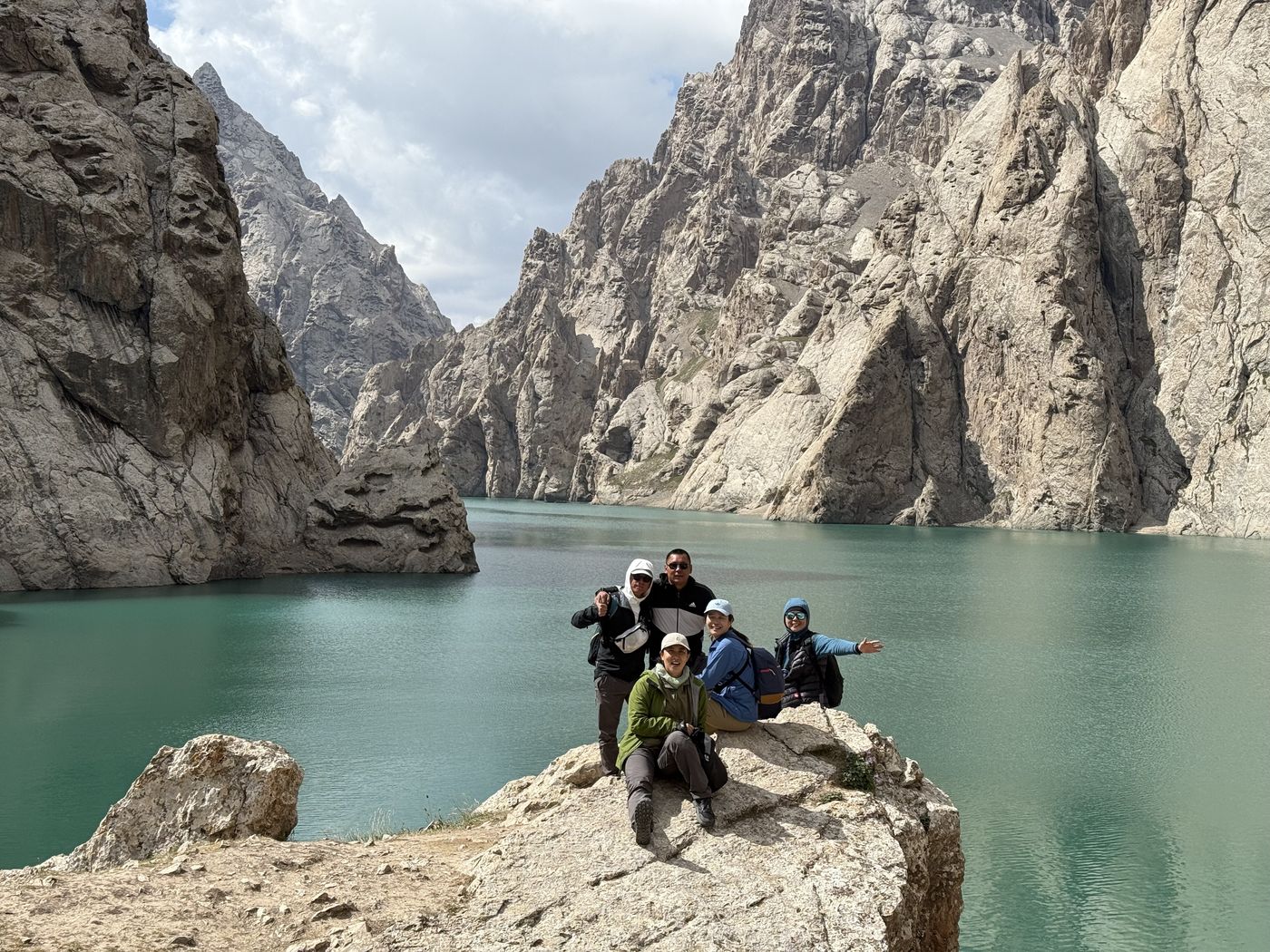 Guests on a rock above Kel-Suu Lake