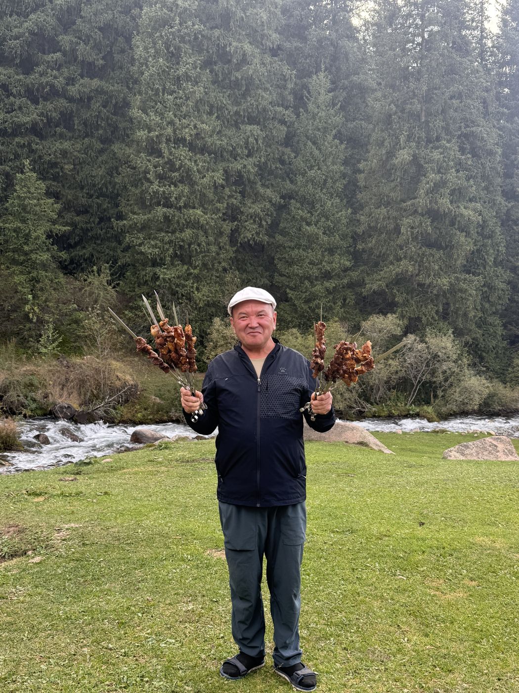 Our host with shashlik skewers by the river