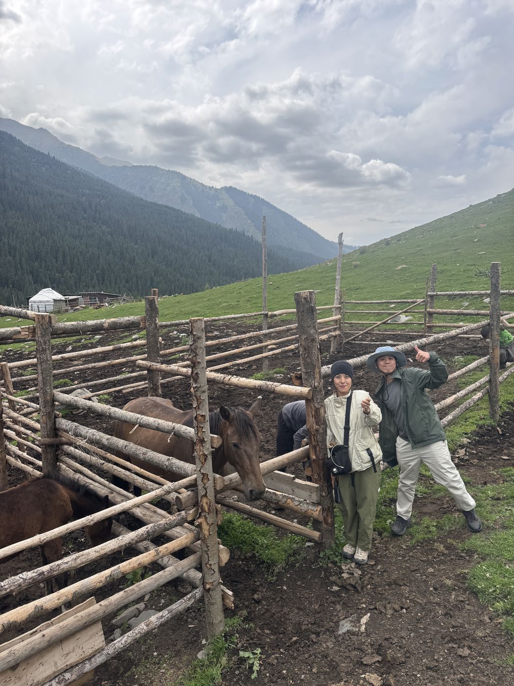 Guests at a wooden corral in a mountain valley