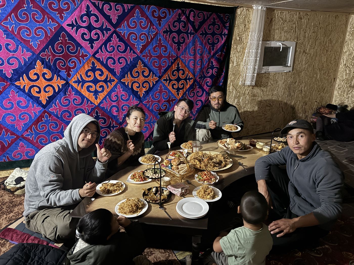 Dinner under a colorful felt carpet