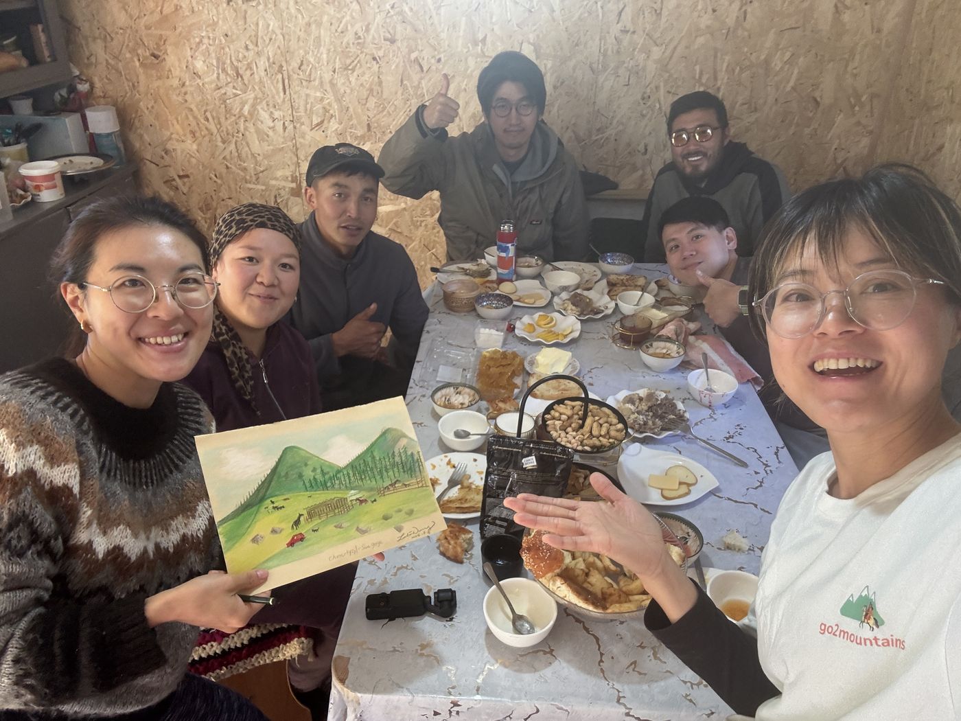 Guests showing a painting at a family dinner